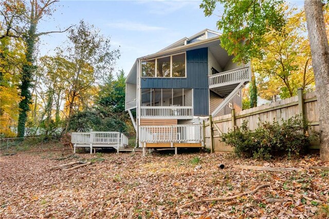 rear view of house with a deck and a sunroom