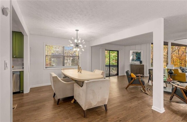 dining area featuring dark hardwood / wood-style flooring, a chandelier, and a textured ceiling