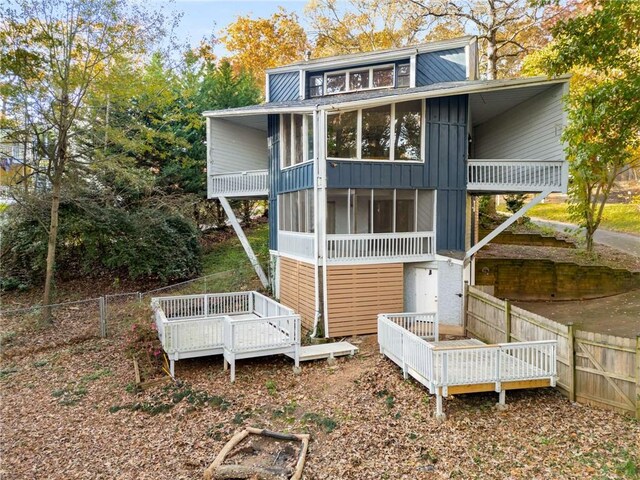 back of house featuring a deck and a sunroom