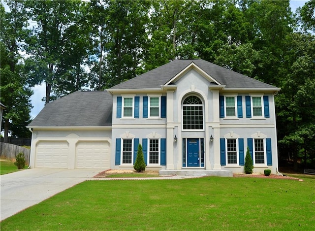 colonial house with a garage and a front lawn