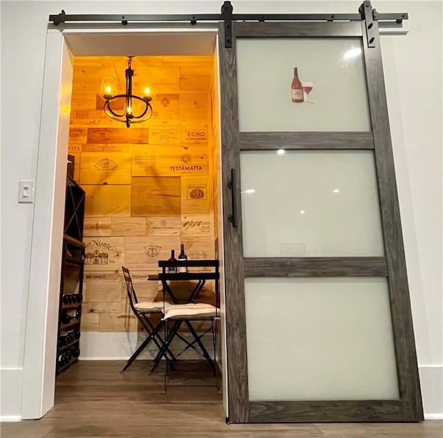 exterior space featuring an inviting chandelier and wood finished floors