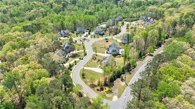 birds eye view of property with a forest view and a residential view