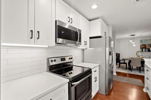 kitchen featuring light countertops, white cabinetry, and stainless steel appliances