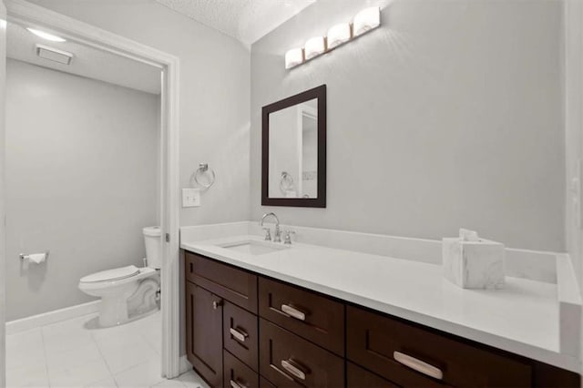 bathroom featuring vanity, toilet, a textured ceiling, baseboards, and visible vents