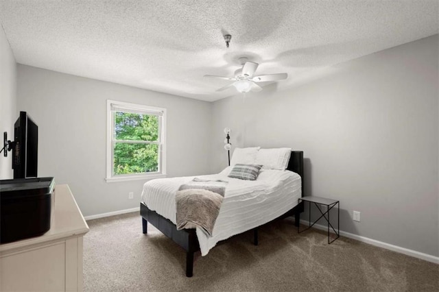bedroom with baseboards, carpet, a ceiling fan, and a textured ceiling