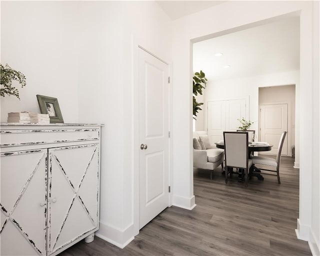 interior space featuring baseboards and wood finished floors