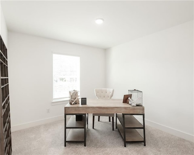 office space with light carpet and baseboards