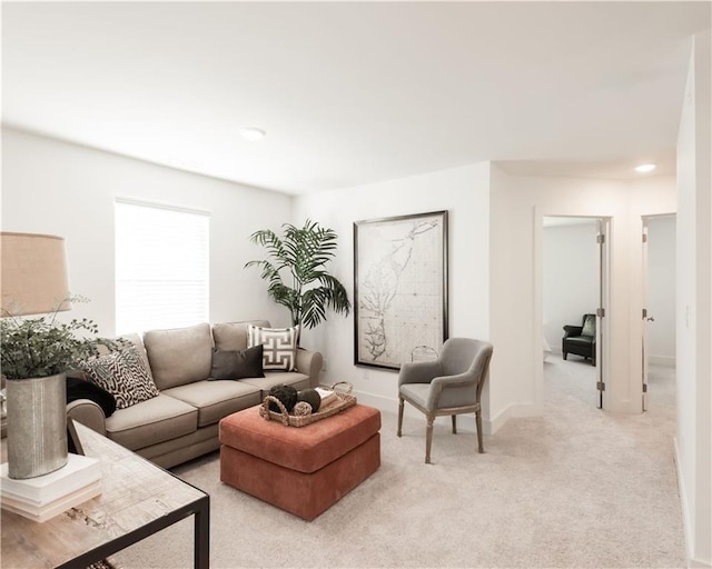 living room featuring light carpet and baseboards