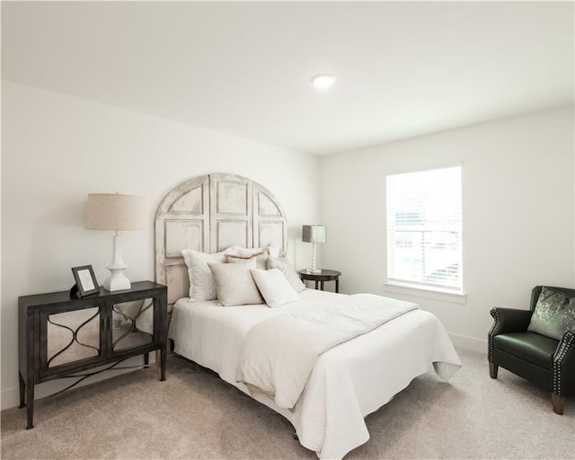 carpeted bedroom featuring baseboards