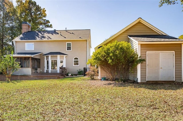 rear view of house with a sunroom and a yard