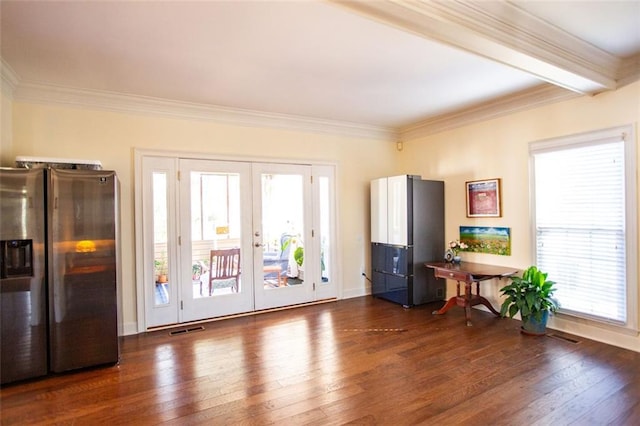 misc room with dark wood-type flooring, plenty of natural light, and crown molding