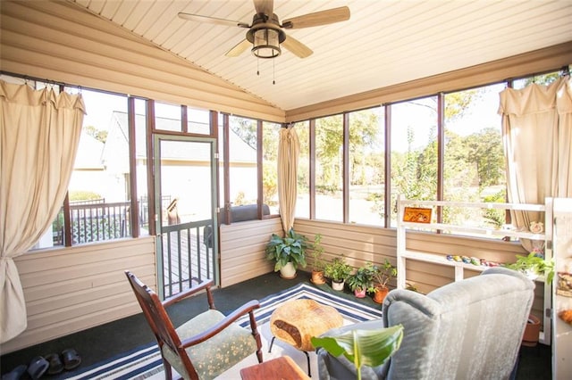 sunroom / solarium featuring vaulted ceiling, ceiling fan, and wood ceiling