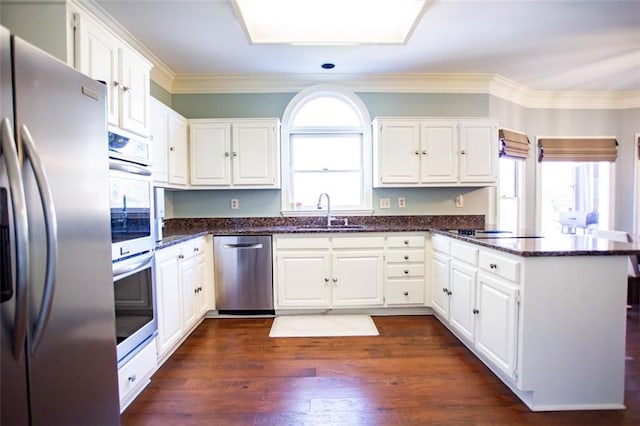 kitchen featuring sink, white cabinetry, dark hardwood / wood-style flooring, and stainless steel appliances