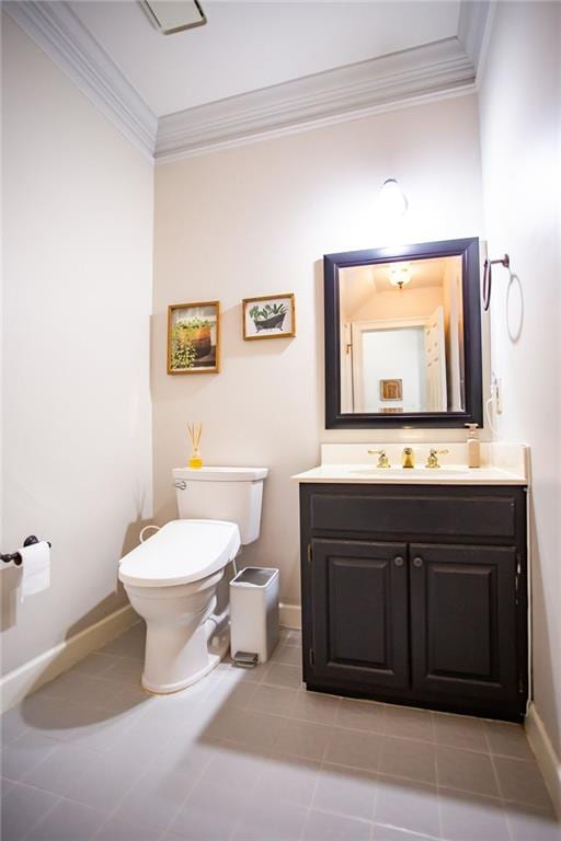 bathroom with vanity, toilet, tile patterned floors, and crown molding