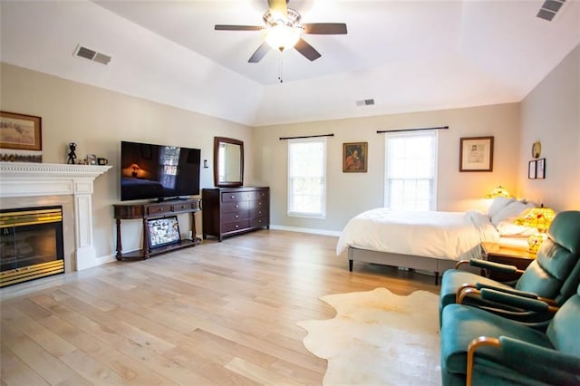 bedroom featuring light wood-type flooring, ceiling fan, and vaulted ceiling