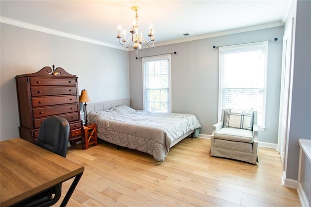 bedroom with light hardwood / wood-style floors, ornamental molding, and an inviting chandelier