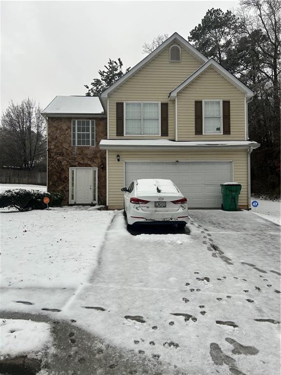 traditional-style house with driveway and an attached garage