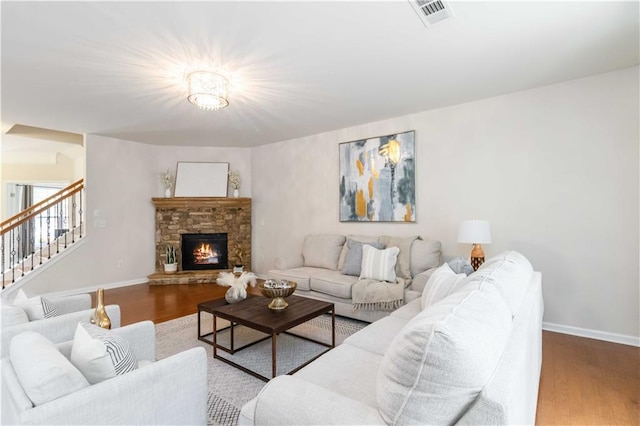 441 Spring View Dr, Woodstock, GA 30188 - living area with wood finished floors, stairway, and a stone fireplace