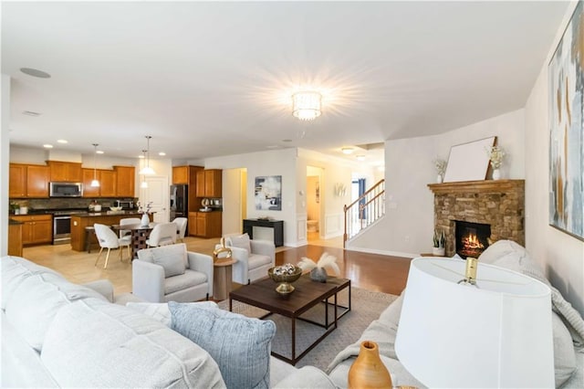 441 Spring View Dr, Woodstock, GA 30188 - living area featuring a stone fireplace, stairs, and recessed lighting