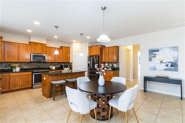 441 Spring View Dr, Woodstock, GA 30188 - kitchen featuring stainless steel appliances, backsplash, brown cabinets, light tile patterned floors, and recessed lighting