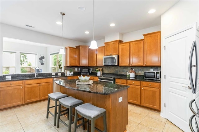 441 Spring View Dr, Woodstock, GA 30188 - kitchen with appliances with stainless steel finishes, light tile patterned floors, brown cabinetry, and recessed lighting