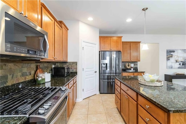 441 Spring View Dr, Woodstock, GA 30188 - kitchen with stainless steel appliances, brown cabinets, backsplash, dark stone counters, and recessed lighting