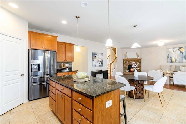 441 Spring View Dr, Woodstock, GA 30188 - kitchen with stainless steel fridge with ice dispenser, light tile patterned flooring, a kitchen breakfast bar, a kitchen island, and recessed lighting