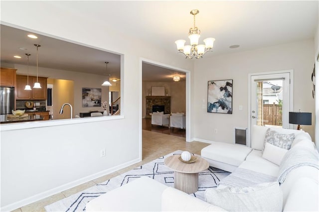 441 Spring View Dr, Woodstock, GA 30188 - living room with a chandelier, light tile patterned flooring, recessed lighting, and a fireplace