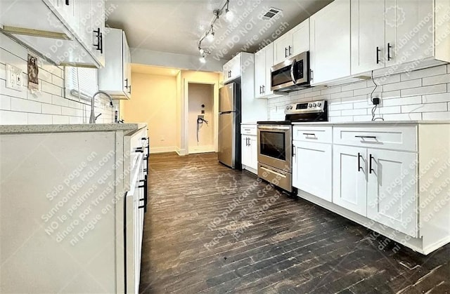1914 N Ave NW, Atlanta, GA 30318 - kitchen featuring appliances with stainless steel finishes, dark wood finished floors, backsplash, and white cabinets