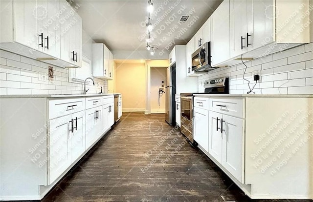 1914 N Ave NW, Atlanta, GA 30318 - kitchen featuring stainless steel appliances, dark wood-type flooring, decorative backsplash, white cabinets, and light countertops