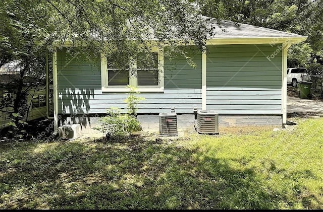 1914 N Ave NW, Atlanta, GA 30318 - view of home's exterior with a cooling unit and roof with shingles