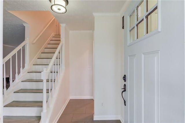 6006 Lanier Heights Cir, Buford, GA 30518 - tiled foyer with crown molding, baseboards, stairs, and a textured ceiling