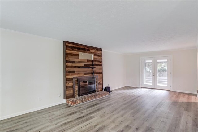 6006 Lanier Heights Cir, Buford, GA 30518 - unfurnished living room with ornamental molding, wood finished floors, a fireplace, and baseboards