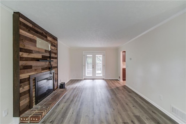 6006 Lanier Heights Cir, Buford, GA 30518 - unfurnished living room with a fireplace, french doors, wood finished floors, crown molding, and baseboards