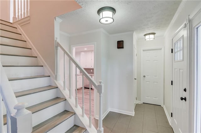 6006 Lanier Heights Cir, Buford, GA 30518 - foyer with a textured ceiling, baseboards, stairs, and ornamental molding