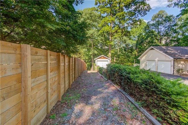 6006 Lanier Heights Cir, Buford, GA 30518 - view of yard featuring fence, an outbuilding, and a detached garage