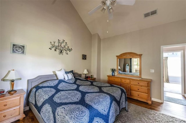 bedroom with ceiling fan, dark hardwood / wood-style floors, and high vaulted ceiling