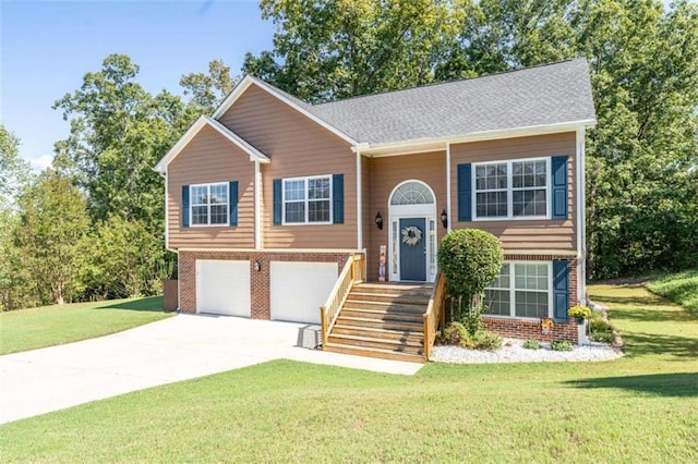 raised ranch featuring a front yard and a garage