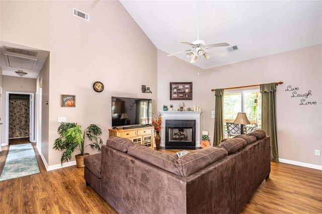 living room with wood-type flooring, ceiling fan, and high vaulted ceiling