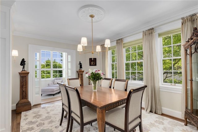 1325 Peachtree St NE Unit 401, Atlanta, GA 30309 - dining space featuring baseboards, a notable chandelier, ornamental molding, and light wood finished floors