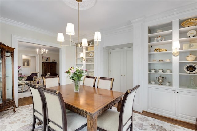 1325 Peachtree St NE Unit 401, Atlanta, GA 30309 - dining area featuring crown molding, a notable chandelier, built in features, and light wood-type flooring