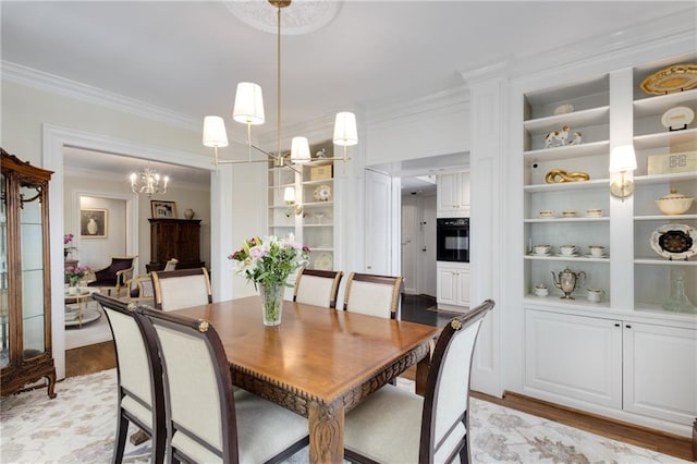 1325 Peachtree St NE Unit 401, Atlanta, GA 30309 - dining space with light wood-style floors, ornamental molding, built in features, and a notable chandelier