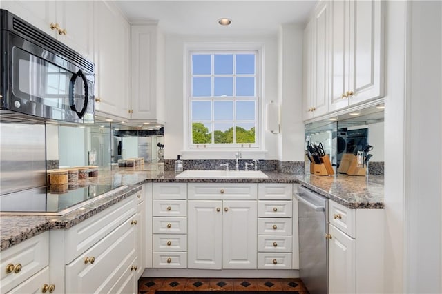 1325 Peachtree St NE Unit 401, Atlanta, GA 30309 - kitchen with white cabinets, stone countertops, a sink, and black appliances