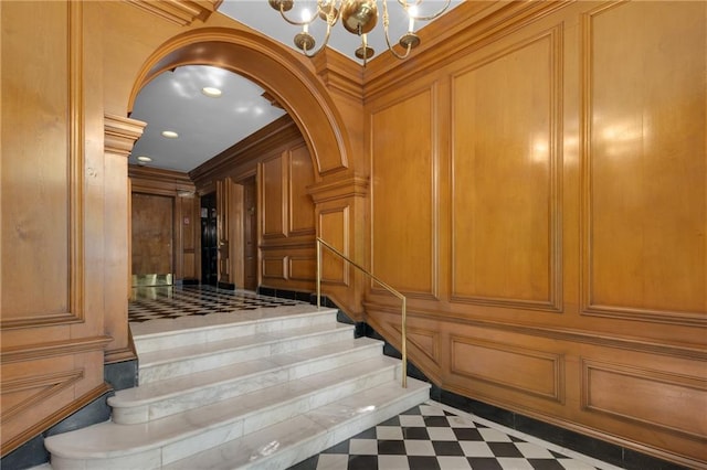 1325 Peachtree St NE Unit 401, Atlanta, GA 30309 - staircase with arched walkways, a decorative wall, and a notable chandelier