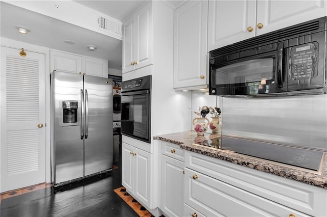 1325 Peachtree St NE Unit 401, Atlanta, GA 30309 - kitchen with white cabinetry, light stone countertops, visible vents, and black appliances