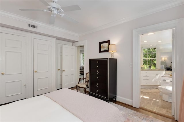 1325 Peachtree St NE Unit 401, Atlanta, GA 30309 - bedroom with visible vents, crown molding, a closet, baseboards, and ensuite bathroom