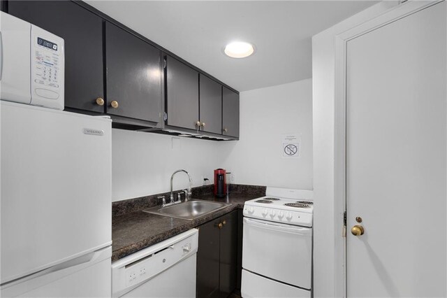 1325 Peachtree St NE Unit 401, Atlanta, GA 30309 - kitchen featuring white appliances, dark countertops, dark cabinetry, and a sink