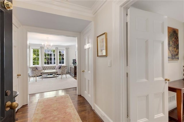 1325 Peachtree St NE Unit 401, Atlanta, GA 30309 - hallway with baseboards, ornamental molding, dark wood finished floors, and a notable chandelier
