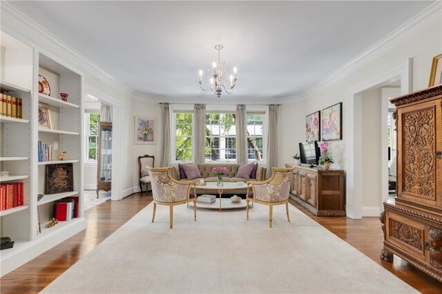 1325 Peachtree St NE Unit 401, Atlanta, GA 30309 - living room with an inviting chandelier, ornamental molding, dark wood finished floors, and a healthy amount of sunlight