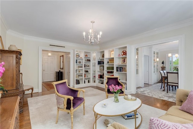 1325 Peachtree St NE Unit 401, Atlanta, GA 30309 - living area with an inviting chandelier, ornamental molding, wood finished floors, and built in shelves